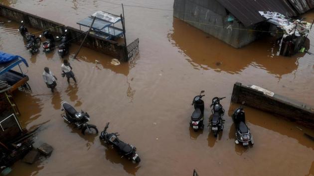 People wade along a waterlogged road after heavy rains following Cyclone Nivar landfall, in Puducherry on November 26, 2020.(AFP photo) People wade along a waterlogged road after heavy rains following Cyclone Nivar landfall, in Puducherry on November 26, 2020.(AFP photo)