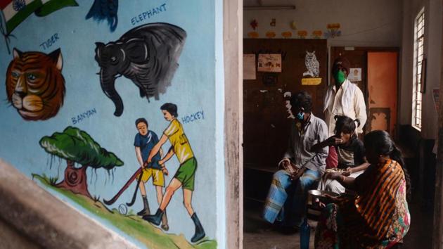 Residents eat a meal at a relief camp set up in a school in Puducherry on November 25. According to officials, over one lakh people were evacuated across Tamil Nadu and more than 1,000 people shifted to safer places in Puducherry by November 25, HT reported. (Arun Sankar / AFP) 