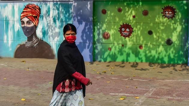 A woman wearing face mask walks past a mural on novel coronavirus and protective measures, in New Delhi.(PTI) A woman wearing face mask walks past a mural on novel coronavirus and protective measures, in New Delhi.(PTI)