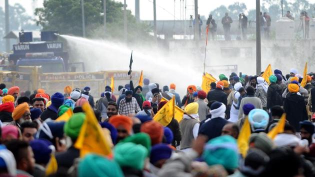 The Haryana Police eventually used water cannons to disperse the farmers, who had gathered in large numbers in tractor-trolleys, when they started removing the concrete barricades. But when that did not deter the farmers, they used tear gas. While it delayed the crossing over, farmers were determined and have continued their march to Delhi. (Bharat Bhushan / HT Photo) The Haryana Police eventually used water cannons to disperse the farmers, who had gathered in large numbers in tractor-trolleys, when they started removing the concrete barricades. But when that did not deter the farmers, they used tear gas. While it delayed the crossing over, farmers were determined and have continued their march to Delhi. (Bharat Bhushan / HT Photo)