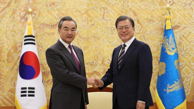 South Korean President Moon Jae-in, right, poses with Chinese Foreign Minister Wang Yi for a photo.(AP) South Korean President Moon Jae-in, right, poses with Chinese Foreign Minister Wang Yi for a photo.(AP)
