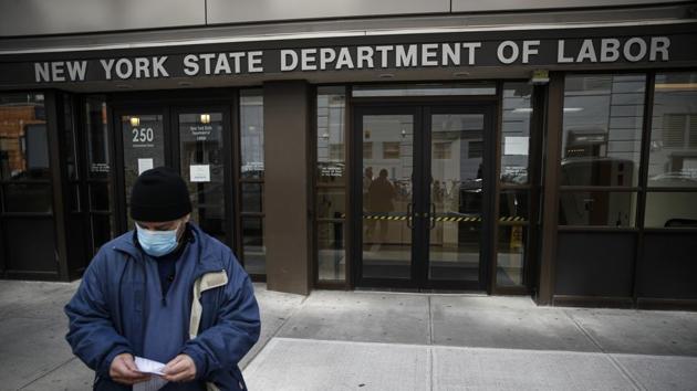 Visitors to the Department of Labor are turned away at the door by personnel due to closures over coronavirus concerns on March 18, 2020, in New York.(AP File Photo)