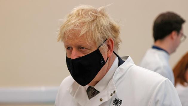 Britain's Prime Minister Boris Johnson wearing a face mask speaks with staff during a visit to the Public Health England site at the Porton Down science park, near Salisbury, Britain November 27, 2020. Adrian Dennis/Pool via REUTERS(REUTERS) Britain's Prime Minister Boris Johnson wearing a face mask speaks with staff during a visit to the Public Health England site at the Porton Down science park, near Salisbury, Britain November 27, 2020. Adrian Dennis/Pool via REUTERS(REUTERS)