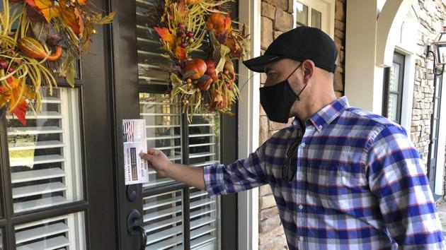 Garrett Bess, vice president of government relations and communications for the conservative activist group Heritage Action For America, leaves information at a residence in a subdivision in Milton.(AP file photo) Garrett Bess, vice president of government relations and communications for the conservative activist group Heritage Action For America, leaves information at a residence in a subdivision in Milton.(AP file photo)