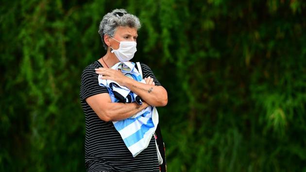 A woman holds onto the iconic no. 10 Maradona jersey in Benavidez, Buenos Aires, Argentina on November 25. (Ronaldo Schemidt / AFP)