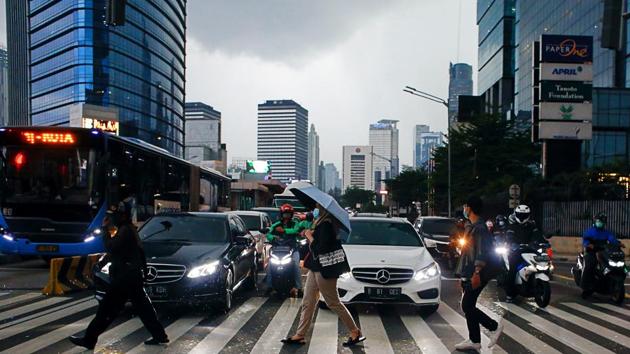People wearing protective face masks cross the street amid the coronavirus disease (Covid-19) outbreak in Jakarta, Indonesia.(Reuters) People wearing protective face masks cross the street amid the coronavirus disease (Covid-19) outbreak in Jakarta, Indonesia.(Reuters)