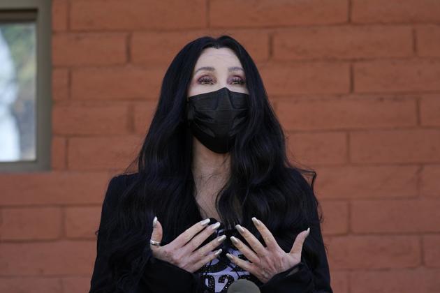 FILE - In this Oct. 26, 2020, file photo, Cher speaks near a polling station as she campaigns for Democratic presidential candidate Joe Biden, in Phoenix. (AP) FILE - In this Oct. 26, 2020, file photo, Cher speaks near a polling station as she campaigns for Democratic presidential candidate Joe Biden, in Phoenix. (AP)