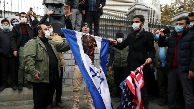 Protesters burn the U.S. and Israeli flags during a demonstration against the the killing of Mohsen Fakhrizadeh.(REUTERS) Protesters burn the U.S. and Israeli flags during a demonstration against the the killing of Mohsen Fakhrizadeh.(REUTERS)