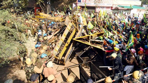 Farmers bring down barricades installed during the Delhi Chalo march against the new farm reform laws, at Punjab Haryana border. (Photo by Sanjeev Kumar/Hindustan Times) Farmers bring down barricades installed during the Delhi Chalo march against the new farm reform laws, at Punjab Haryana border. (Photo by Sanjeev Kumar/Hindustan Times)