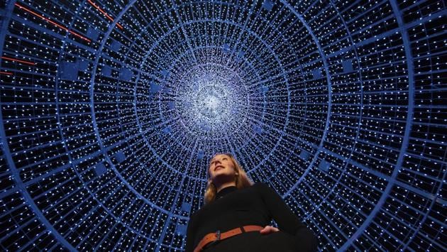 Artist Sian Bliss poses for a photograph inside her installation named ‘Aurora Arbour’, towering above her is London’s tallest LED Christmas tree featuring 100,000 lights, at the launch of Wembley Park’s Christmas display, ‘United in Light’, on November 26. (David Parry / AP) 
