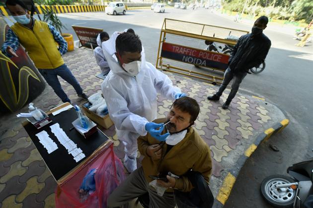 A health worker collects samples for Covid-19 test at Delhi-Noida border.(PTI)