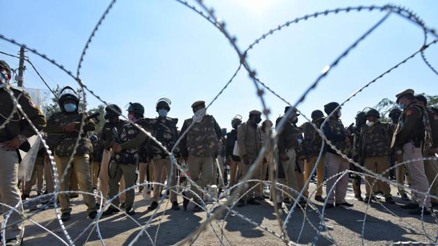 Police personnel behind barbed wire laid out to impede advancing farmers at Singhu Border on November 27. Most protesters are from Punjab, but there is a substantial number from Haryana as well. There has been scattered support for the “Delhi Chalo” protest from Uttar Pradesh, Rajasthan, Madhya Pradesh and Uttarakhand, PTI reported. (Sanchit Khanna / HT Photo) 