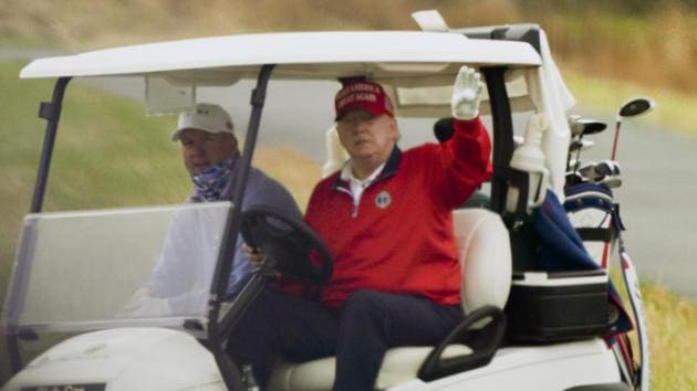 President Donald Trump waves from a golf cart as he plays golf at Trump National Golf Club, Friday, Nov. 27, 2020, in Sterling.(AP)