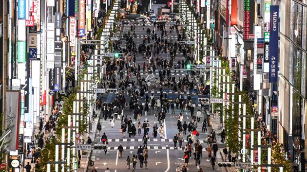 People walk on a street in Tokyo's Ginza area on November 23. (Charly Triballeau / AFP) 