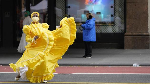 A dancer warms up along 34th Street while waiting to perform during a pre-taping of the Macy’s Thanksgiving Day Parade in front of the flagship store in New York, US on November 25. Thanksgiving holiday was celebrated across the world on November 26.  (Mary Altaffer / AP) 