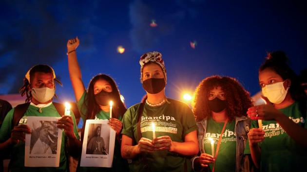 Demonstrators take a part in a protest in front of a Carrefour supermarket in Brasilia, Brazil on November 26. Widespread protests broke out across Brazil after a video of a Black man Joao Alberto Silveira Freitas being beaten to death by white security guards at a Carrefour supermarket in Porto Alegre on November 19 went viral on social media. (Adriano Machado / REUTERS) 