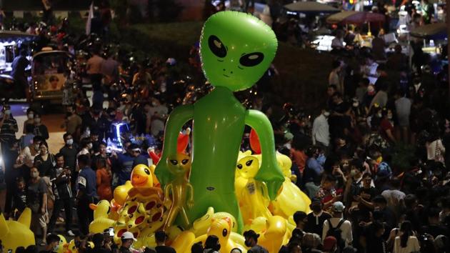 Protesters gather balloons shaped like aliens - to mock accusations that foreigners fund and direct their movement and Inflatable yellow ducks, which have become good-humored symbols of resistance- during a rally Friday, Nov. 27, 2020 in Bangkok, Thailand. (AP) Protesters gather balloons shaped like aliens - to mock accusations that foreigners fund and direct their movement and Inflatable yellow ducks, which have become good-humored symbols of resistance- during a rally Friday, Nov. 27, 2020 in Bangkok, Thailand. (AP)