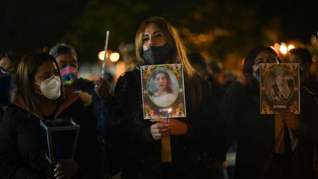 Women hold photographs during a vigil in memory of women murdered on the eve of International Day of No Violence Against Women at Constitution Square in Guatemala City, Guatemala on November 24. According to the Guatemalan Women’s Group, some 444 women have been murdered this year in Guatemala as of November 24, AFP reported. (Johan Ordonez / AFP) 