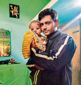 Pannelal Rajbhar with his three-month-old son Shashank at their home in Varanasi at Uttar Pradesh. (HT) Pannelal Rajbhar with his three-month-old son Shashank at their home in Varanasi at Uttar Pradesh. (HT)
