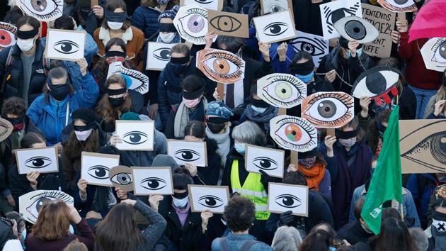 Demonstrators hold placards as they gather at the Place de la Republique square in Paris on November 28. Tens of thousands took to the streets to protest against new security legislation that would criminalise the publication of images of on-duty police officers with the intent of harming their physical or psychological integrity, AFP reported. (Thomas Coex / AFP) Demonstrators hold placards as they gather at the Place de la Republique square in Paris on November 28. Tens of thousands took to the streets to protest against new security legislation that would criminalise the publication of images of on-duty police officers with the intent of harming their physical or psychological integrity, AFP reported. (Thomas Coex / AFP)