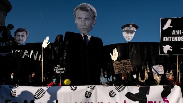 Demonstrators hold effigies of French President Emmanuel Macron, French Interior Minister Gerald Darmanin and Paris police prefect Didier Lallement at the Place de la Republique in Paris on November 28. Macron said on November 27 that the images of the beating of black music producer Michel Zecler by police officers in Paris “shame us.” The incident had magnified concerns about alleged systemic racism in the police force, AFP reported. (Joel Saget / AFP) Demonstrators hold effigies of French President Emmanuel Macron, French Interior Minister Gerald Darmanin and Paris police prefect Didier Lallement at the Place de la Republique in Paris on November 28. Macron said on November 27 that the images of the beating of black music producer Michel Zecler by police officers in Paris “shame us.” The incident had magnified concerns about alleged systemic racism in the police force, AFP reported. (Joel Saget / AFP)