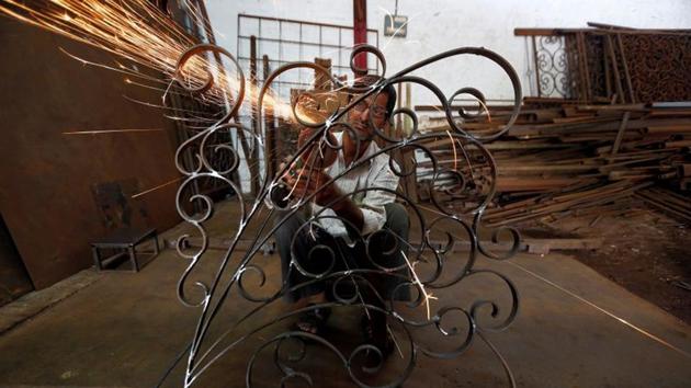 A worker grinds a metal window grill at a steel and iron manufacturing unit in Ahmedabad, India.(Reuters/ File photo) A worker grinds a metal window grill at a steel and iron manufacturing unit in Ahmedabad, India.(Reuters/ File photo)