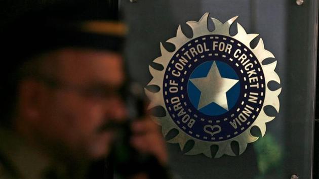 A policeman walks past a logo of the Board of Control for Cricket in India (BCCI) during a governing council meeting of the Indian Premier League (IPL) at BCCI headquarters in Mumbai.(REUTERS)