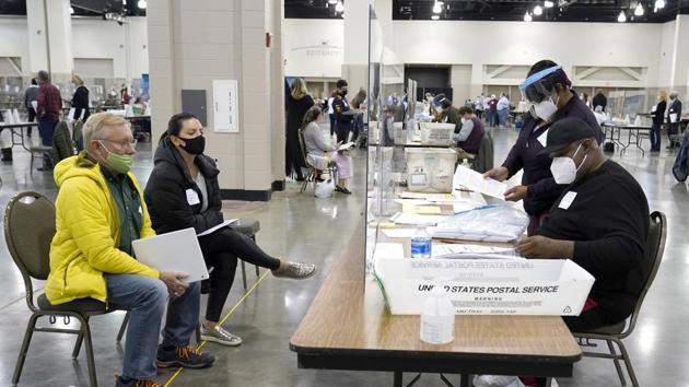 Election workers verify ballots as recount observers watch during a hand recount of presidential votes at the Wisconsin Center in Milwaukee.(AP) Election workers verify ballots as recount observers watch during a hand recount of presidential votes at the Wisconsin Center in Milwaukee.(AP)