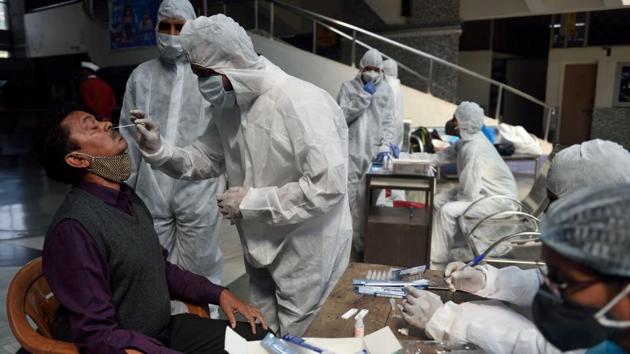 File photo: A healthcare worker takes swab samples of people. (Satish Bate/HT PHOTO) File photo: A healthcare worker takes swab samples of people. (Satish Bate/HT PHOTO)