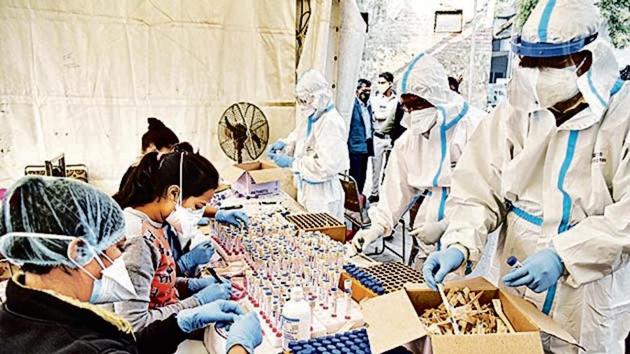 Health workers collect swab samples for Covid-19 tests at Anand Vihar ISBT. Health workers collect swab samples for Covid-19 tests at Anand Vihar ISBT.