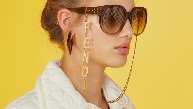 Model wearing eyewear chain.