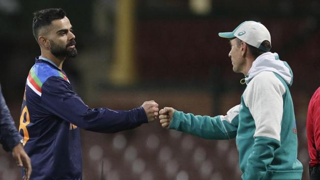 India's Virat Kohli, left, gestures with Australian coach Justin Langer following the one day international cricket match between India and Australia at the Sydney Cricket Ground in Sydney, Australia, Sunday, Nov. 29, 2020. (AP Photo/Rick Rycroft)(AP)