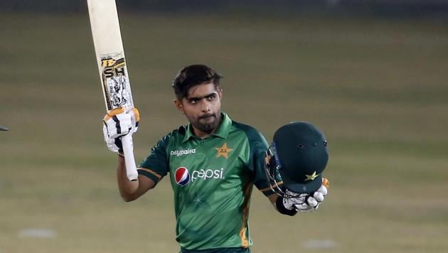 Pakistani batsman Babar Azam raises his bat and helmet(AP)