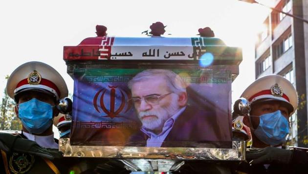 Members of Iranian forces carry the coffin of Iranian nuclear scientist Mohsen Fakhrizadeh during a funeral ceremony.(VIA REUTERS)