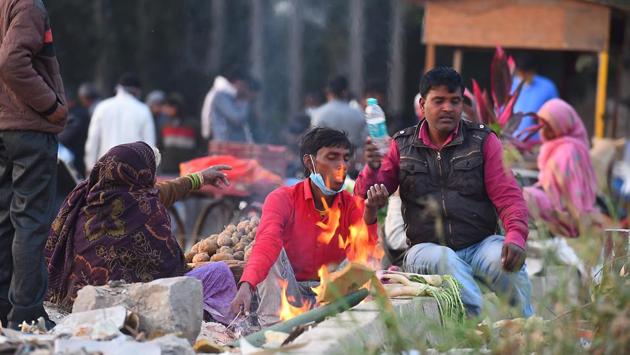 People warm themselves near a bonfire on a cold winter evening near the banks of the river Yamuna in New Delhi on November 26. On November 23, Delhi recorded a minimum of 6.3 degrees Celsius -- its lowest minimum temperature in the month since November 2003, when the city recorded a minimum of 6.1 degrees Celsius, according to Kuldeep Srivastava, head at IMD’s regional forecasting centre. (Raj K Raj / HT Photo) People warm themselves near a bonfire on a cold winter evening near the banks of the river Yamuna in New Delhi on November 26. On November 23, Delhi recorded a minimum of 6.3 degrees Celsius -- its lowest minimum temperature in the month since November 2003, when the city recorded a minimum of 6.1 degrees Celsius, according to Kuldeep Srivastava, head at IMD’s regional forecasting centre. (Raj K Raj / HT Photo)