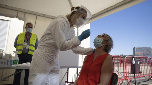 FILE - In this Wednesday, Aug. 5, 2020 file photo, healthcare workers perform tests in a tent at a drive-thru Covid-19 testing site in Antwerp, Belgium.(AP) FILE - In this Wednesday, Aug. 5, 2020 file photo, healthcare workers perform tests in a tent at a drive-thru Covid-19 testing site in Antwerp, Belgium.(AP)