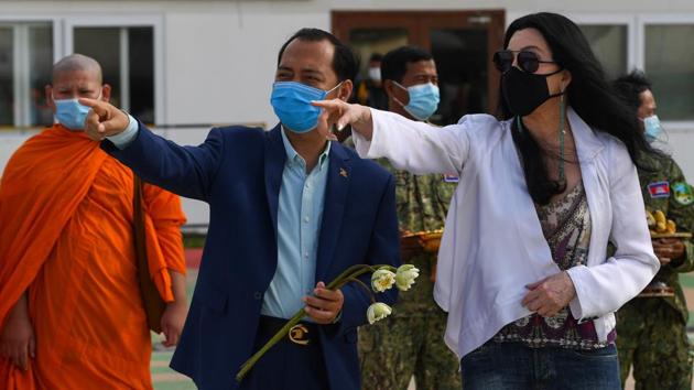 US pop singer Cher (R) and Cambodia's Deputy Minister of Environment Neth Pheaktra await the arrival of a crate containing Kaavan at Siem Reap International Airport on November 30. Efforts by animal rights groups were boosted by spirited social media support from actress and musician Cher. Kaavan arrived in Cambodia to much fanfare -- including a welcome from Cher herself. (Tang Chhin Sothy / AFP)