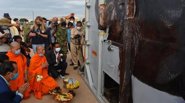 Buddhist monks perform a ceremony to bless the crate containing Kaavan the Asian elephant upon his arrival in Cambodia from Pakistan at Siem Reap International Airport on November 30. The 4,080 kilogram elephant received a warm welcome on arrival from officials, conservationists and the Buddhist monks, who chanted prayers for his harmony and prosperity. (Tang Chhin Sothy / AFP)
