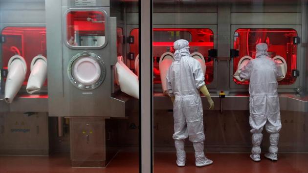 Employees operate a filling machine inside a lab at the Serum Institute of India in Pune on November 30. The total number of Covid-19 tests conducted in India also crossed the 140 million mark on November 30. The first test to diagnose Covid-19 in the country was performed on January 23, and India performed over 900,000 tests on November 30. (Francis Mascarenhas / REUTERS) Employees operate a filling machine inside a lab at the Serum Institute of India in Pune on November 30. The total number of Covid-19 tests conducted in India also crossed the 140 million mark on November 30. The first test to diagnose Covid-19 in the country was performed on January 23, and India performed over 900,000 tests on November 30. (Francis Mascarenhas / REUTERS)