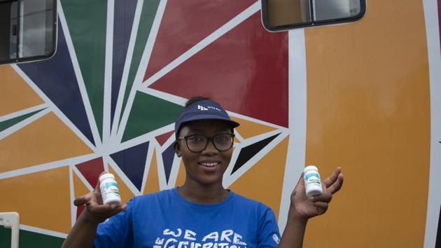 Khanyiswa Kwatsha, who runs a mobile clinic for the Reproductive Health and HIV Institute (RHI) background, shows containers of PrEP medication used in the prevention of HIV infectionin in the Soshanguve Township, north of Pretoria, South Africa. (AP)