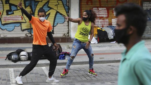 Artists wearing face masks perform on a street open to only pedestrians during weekends in Bengaluru on November 28. 77.79% of the new cases are concentrated in 10 States and UTs at the moment. Maharashtra reported the maximum daily new cases over the last 24 hours, numbering 3,837. Delhi recorded 3,726 new cases while Kerala reported 3,382 new cases. (Aijaz Rahi / AP) Artists wearing face masks perform on a street open to only pedestrians during weekends in Bengaluru on November 28. 77.79% of the new cases are concentrated in 10 States and UTs at the moment. Maharashtra reported the maximum daily new cases over the last 24 hours, numbering 3,837. Delhi recorded 3,726 new cases while Kerala reported 3,382 new cases. (Aijaz Rahi / AP)