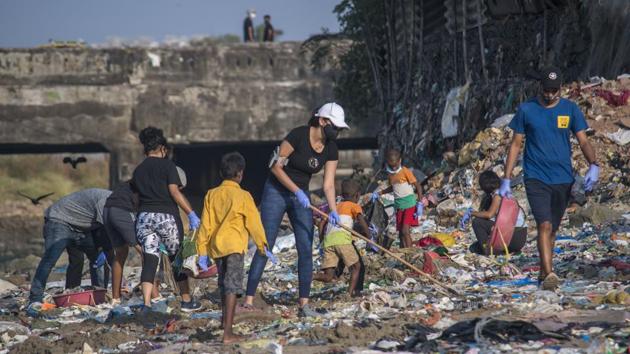 Members of an NGO and the general public take part in a cleanup activity along the Mithi river at Mahim Causeway in Mumbai on November 29. “I do not feel there is any period in the coming days that is crucial. All I can say that until we have a vaccine, everything is crucial. We have to continue with our Covid-19-appropriate behavior,” Dr. Paliwal warned. (Pratik Chorge / HT Photo)