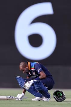 India's batsman Hardik Pandya sits on the ground to restore his energy during the third one-day international cricket match between Australia and India at Manuka Oval in Canberra on December 2, 2020. (Photo by DAVID GRAY / AFP) / / IMAGE RESTRICTED TO EDITORIAL USE - STRICTLY NO COMMERCIAL USE (AFP)