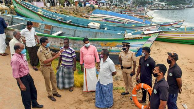 Police personnel and coast guard wardens create awareness among fishermen residing near Vizhinjam seashore in view of Cyclone Burevi, in Thiruvananthapuram.(PTI) Police personnel and coast guard wardens create awareness among fishermen residing near Vizhinjam seashore in view of Cyclone Burevi, in Thiruvananthapuram.(PTI)