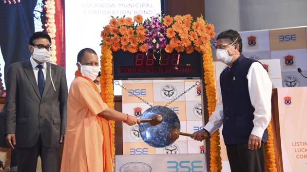 Uttar Pradesh CM Yogi Adityanath rings the bell to mark the listing of Lucknow Nagar Nigam bonds at the BSE, in Mumbai on Wednesday. (PTI Photo) Uttar Pradesh CM Yogi Adityanath rings the bell to mark the listing of Lucknow Nagar Nigam bonds at the BSE, in Mumbai on Wednesday. (PTI Photo)