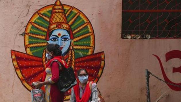 Women wearing face masks wait near a temple inside a hospital premise in Hyderabad. Andhra Pradesh is among the states that have shown a decline in the number of active Covid-19 cases.(File photo) Women wearing face masks wait near a temple inside a hospital premise in Hyderabad. Andhra Pradesh is among the states that have shown a decline in the number of active Covid-19 cases.(File photo)