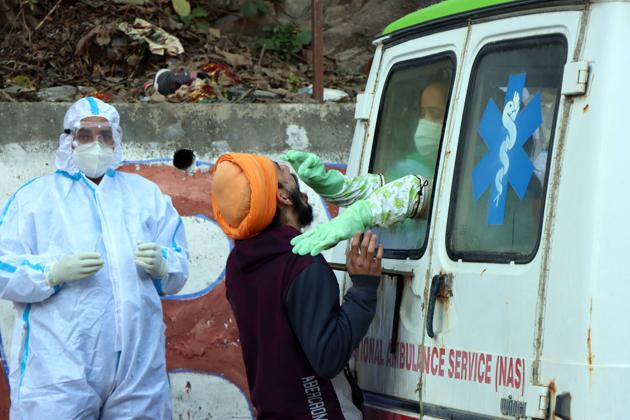 Health staff collect swab samples from a Himachal resident. (File photo) Health staff collect swab samples from a Himachal resident. (File photo)
