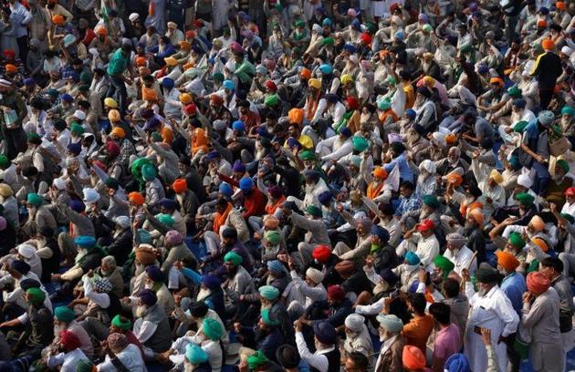 Farmers raising slogans during a protest against the new farm laws at Singhu border near Delhi on Thursday.(Reuters photo)