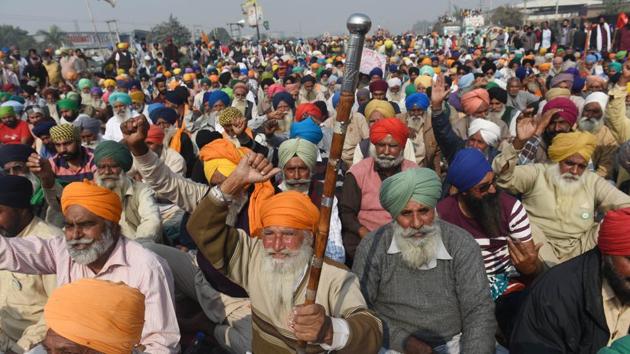 Farmers camping at Singhu Border raise slogans in protest against the centre's farm reform laws near New Delhi on December 1. The protest by cultivators from across North India who have massed at Delhi’s borders to demand the repeal of three contentious laws aimed at opening up farm trade, completed its seventh day on December 3. (Vipin Kumar / HT Photo)