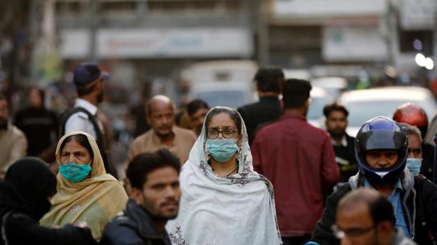 Women wear protective masks as they walk through a crowd along a market as the outbreak of the coronavirus disease (Covid-19) continues, in Karachi, Pakistan.(Reuters) Women wear protective masks as they walk through a crowd along a market as the outbreak of the coronavirus disease (Covid-19) continues, in Karachi, Pakistan.(Reuters)